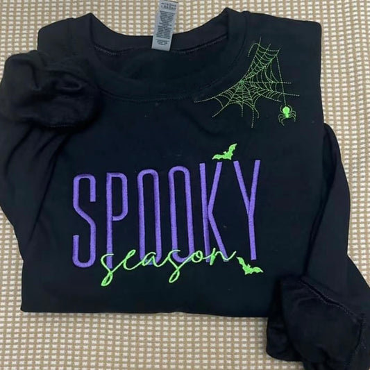 Spooky season with spiderweb neckline purple and green design